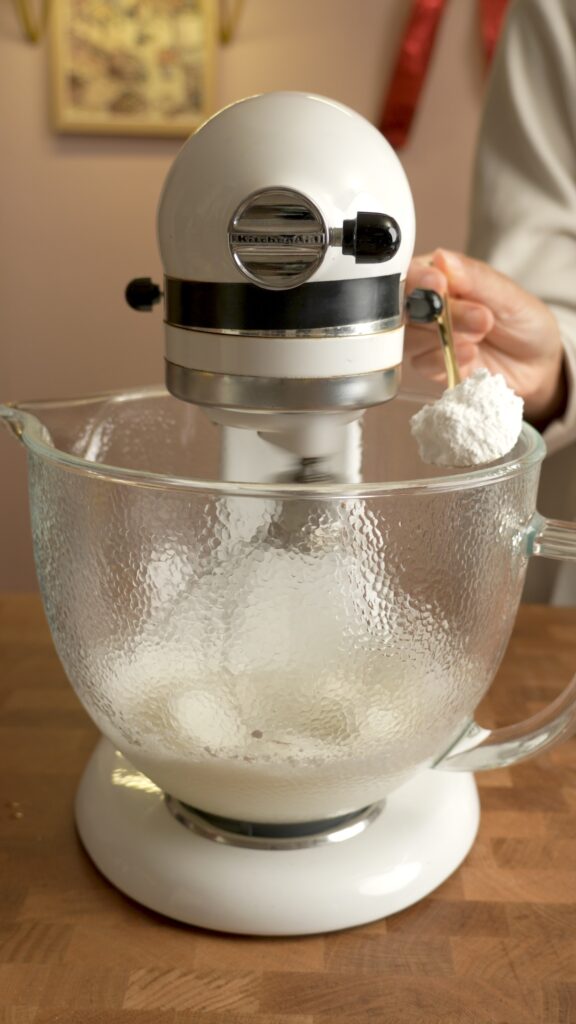 adding powdered sugar to the beginning of the merengue
