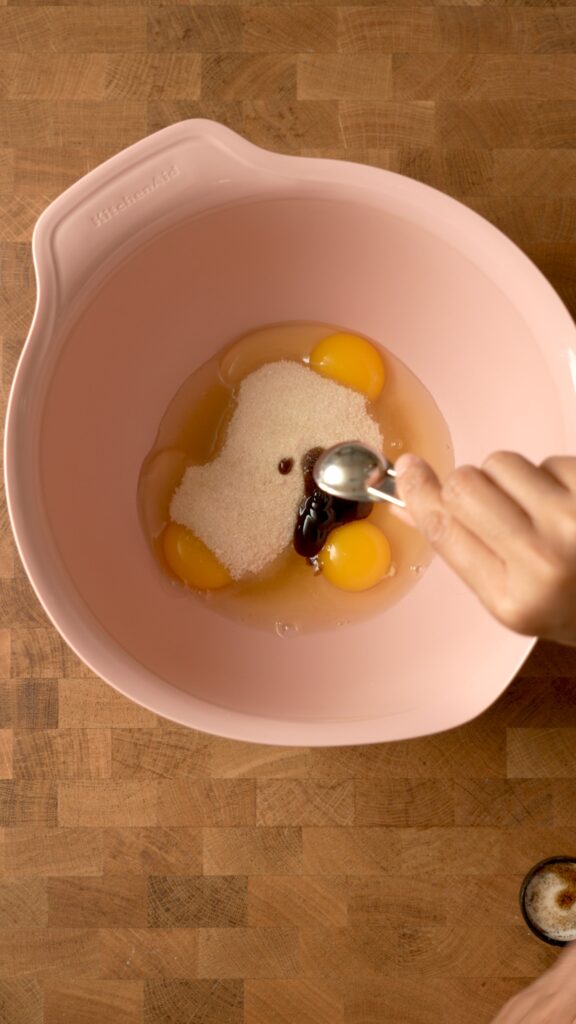 mixing eggs, sugar, vanilla paste, and anise extract