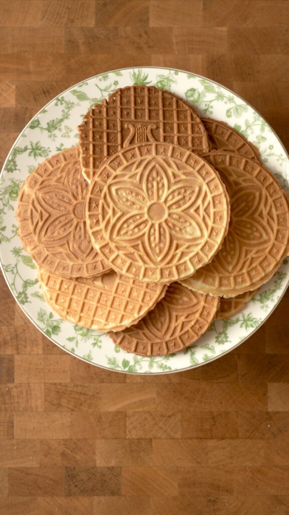 9 pizzelles on a plate