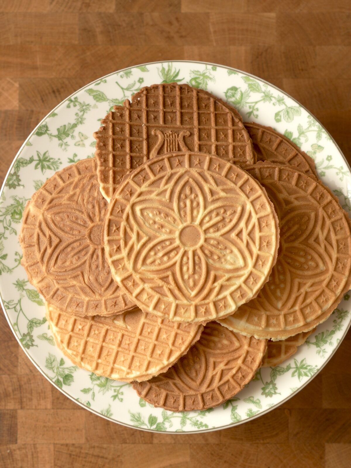 9 pizzelles on a plate