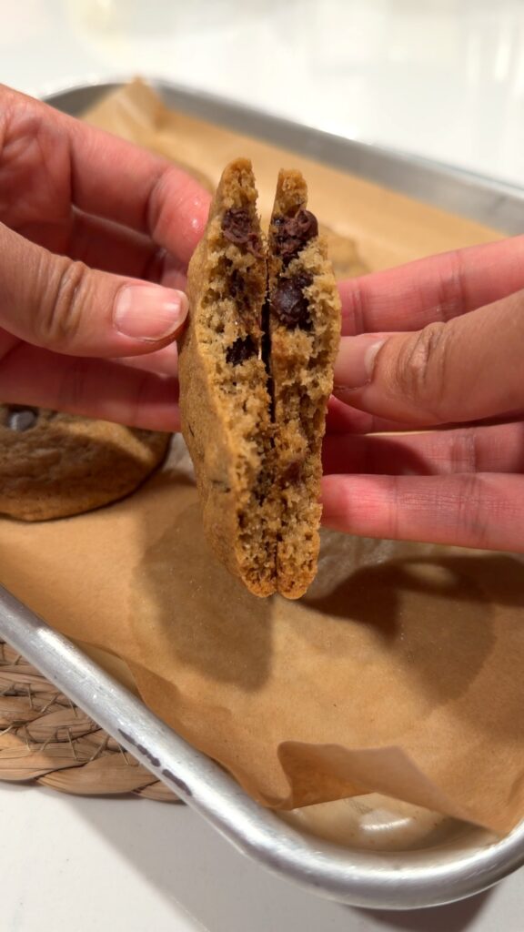 a chocolate chip cookie broken in half to reveal the middle