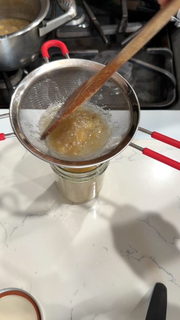 pressing the mixture through the sieve