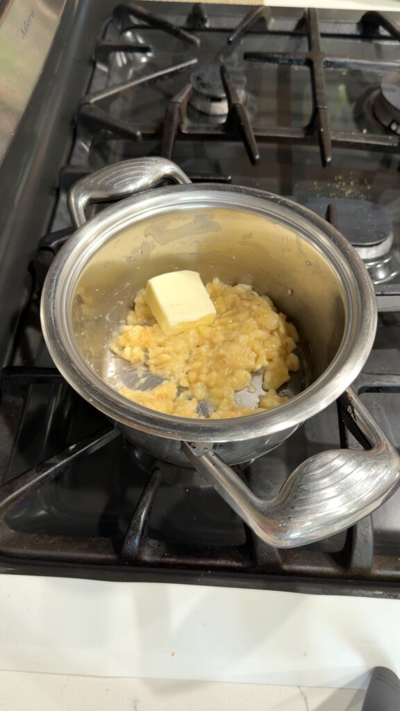 butter added to a pot of mashed bananas