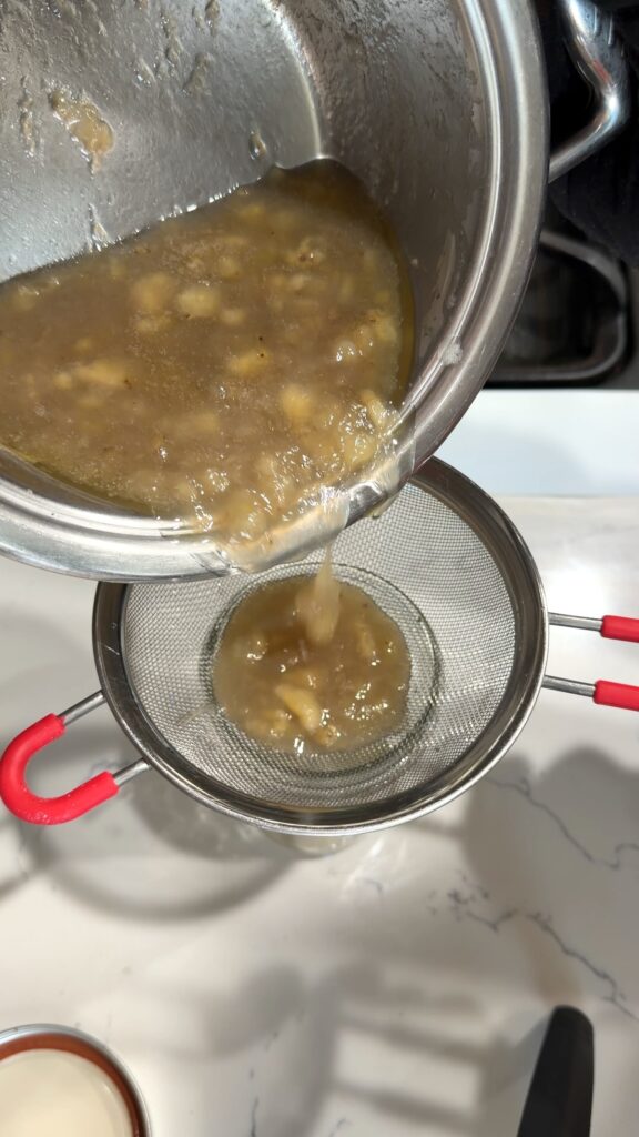 attempting to strain the mixture