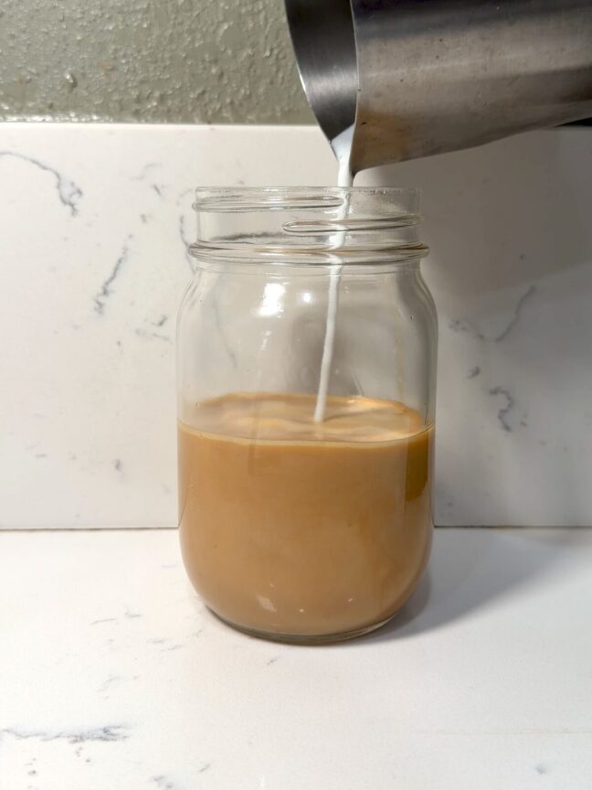 finishing a banana bread latte with milk