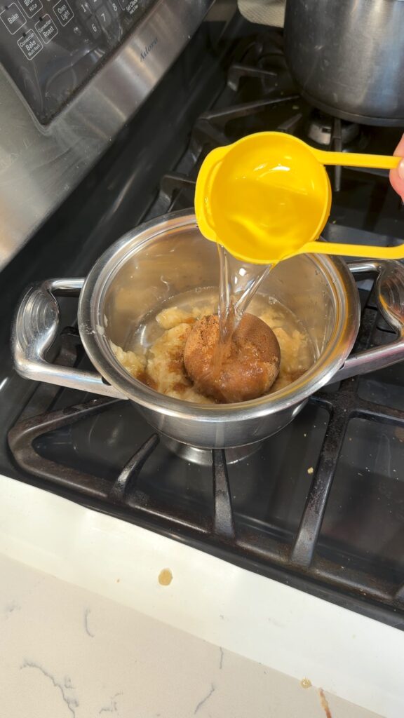 adding water to the mashed banana and brown sugar